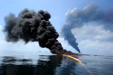 Dark clouds of smoke and fire emerge as oil burns during a controlled fire in the Gulf of Mexico, May 6, 2010. The U.S. Coast Guard, working with BP, local residents and other federal agencies, conducted the burn to help prevent the spread of oil followin