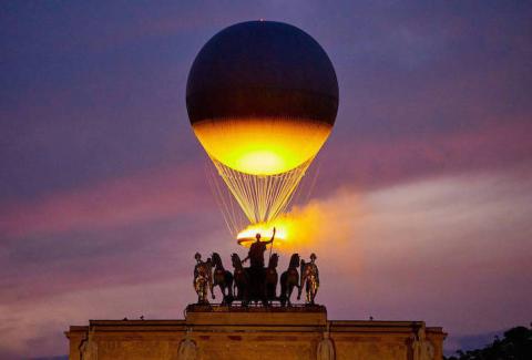 The Cauldron With The Olympic Flame Lit Flies Seen From The Louvre